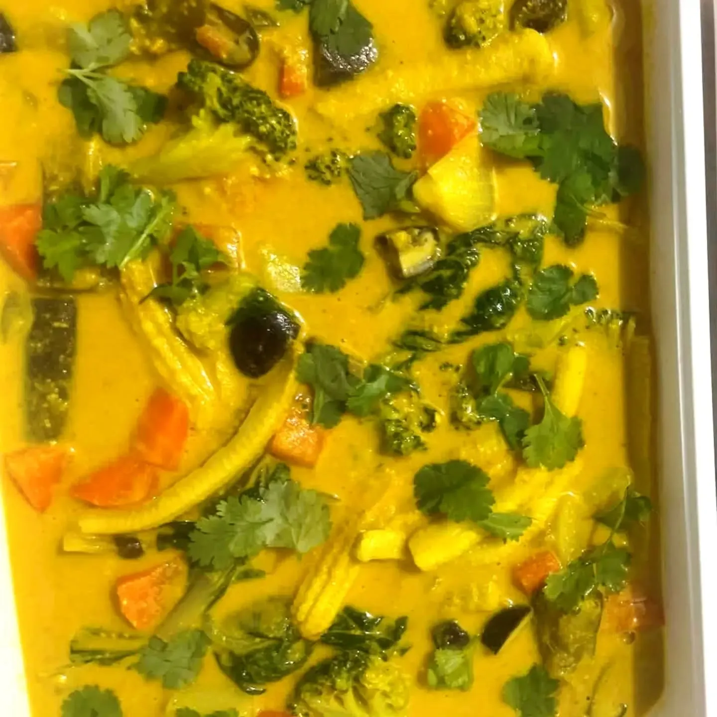 Yellow mixed-vegetable curry with broccoli, baby corn, carrots and eggplant